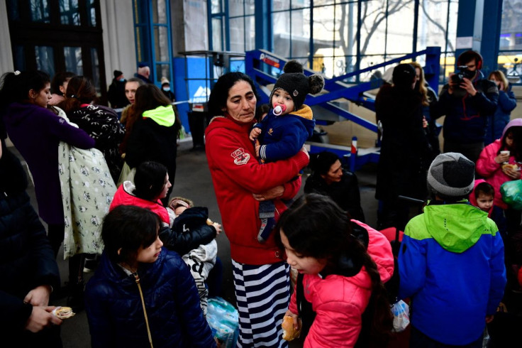 A woman fleeing from Ukraine stands with her son at Nyugati station, after Russia invaded Ukraine, in Budapest, Hungary, February 28, 2022. 