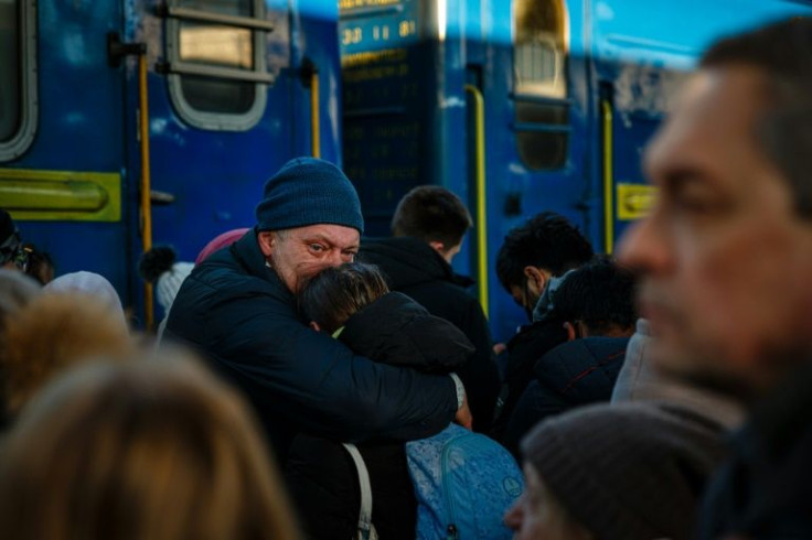 A man says goodbye to his daughter before she boards an evacuation train at Kyiv central train station on February 28, 2022