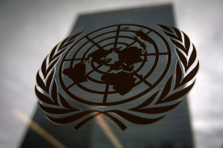 The United Nations headquarters building is pictured though a window with the UN logo in the foreground in the Manhattan borough of New York August 15, 2014. 