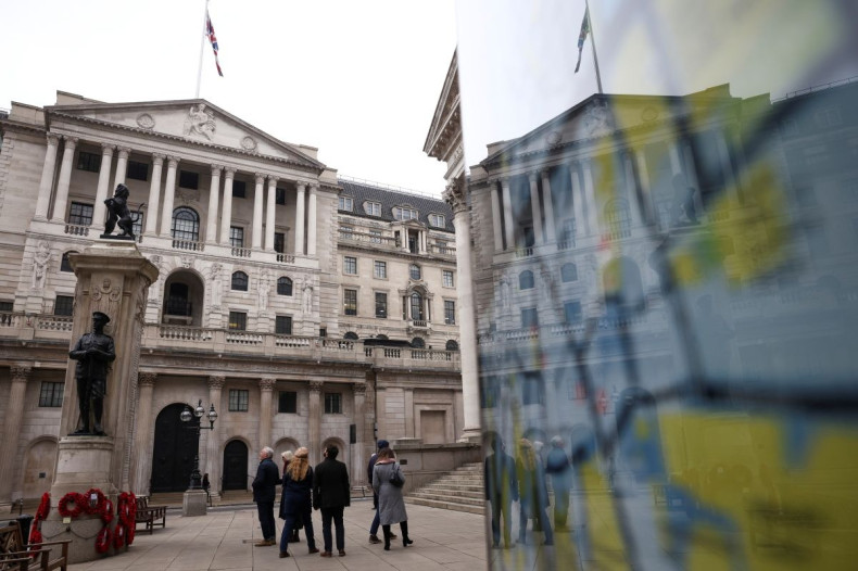 People stand outside the Bank of England in the City of London financial district in London, Britain, January 23, 2022. 