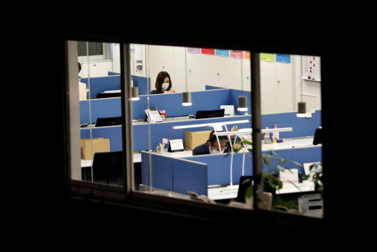 Office workers wearing protective masks, following the coronavirus disease (COVID-19) outbreak, work at a business building in Tokyo, Japan November 27, 2020. 