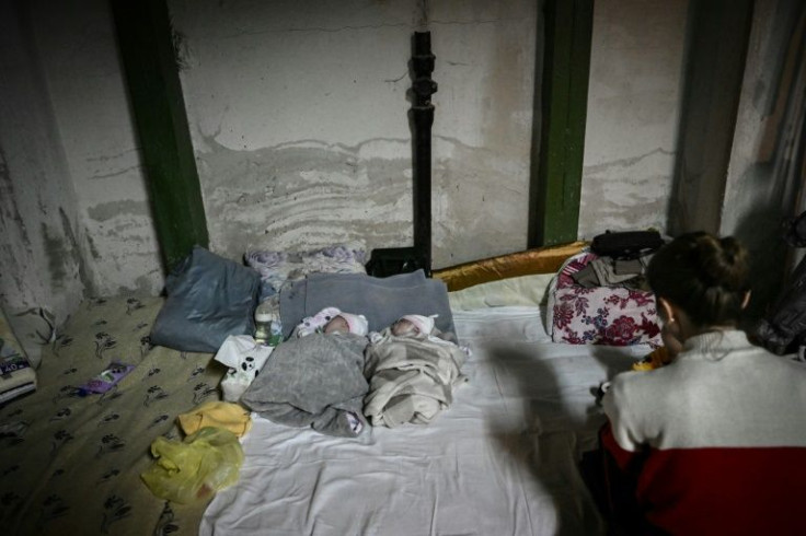 Two babies in the basement of a Kyiv paediatrics hospital which is being used as a bomb shelter