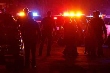 Police officers escort people following a shooting at a church in Sacramento, California, U.S., February 28, 2022. 