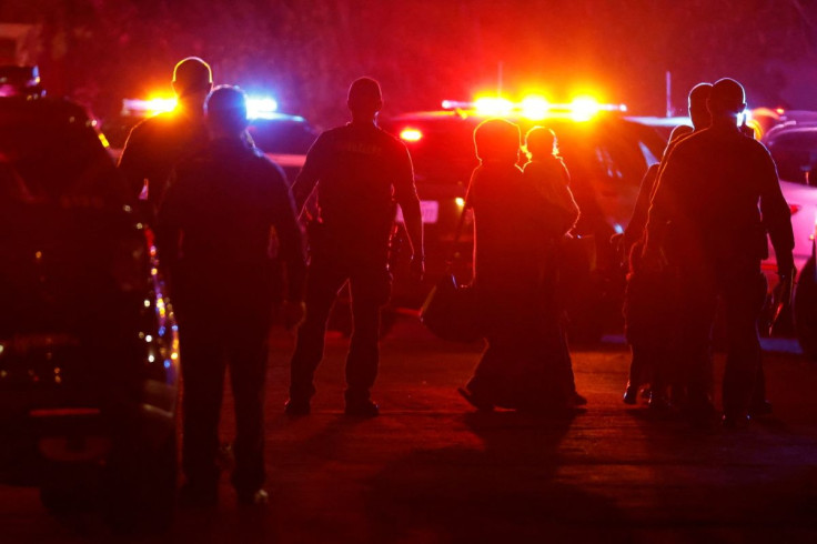 Police officers escort people following a shooting at a church in Sacramento, California, U.S., February 28, 2022. 