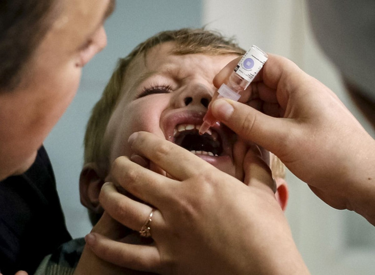 A boy receives polio vaccine drops at a clinic in Kiev, Ukraine, October 21, 2015. 