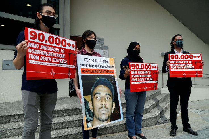 Activists hold placards and a poster against the imminent execution of Nagaenthran Dharmalingam, who was sentenced to death for drug trafficking in Singapore, outside the Singapore High Commission in Kuala Lumpur, Malaysia November 23, 2021. 