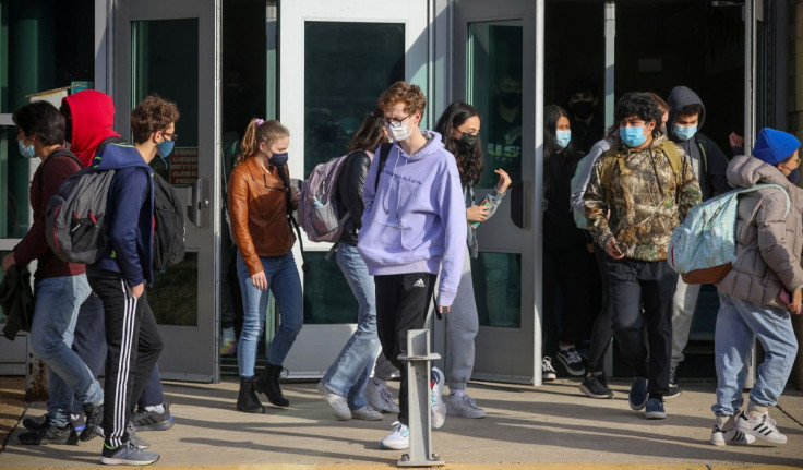 Students leave Washington-Liberty High School in Arlington County which is one of several school districts which sued to stop the mask-optional order by Governor Glenn Youngkin (R), in Arlington, Virginia, U.S., January 25, 2022. 