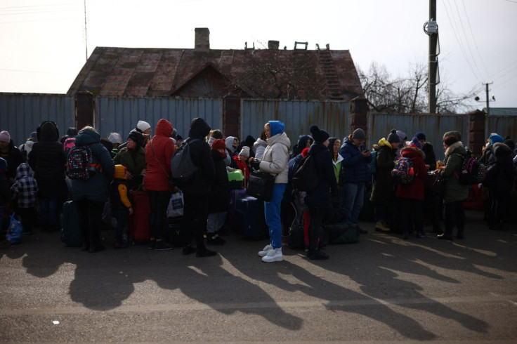 People who have fled Russia's invasion of Ukraine wait at the Shehyni border crossing to enter Poland, near Mostyska, Ukraine March 1, 2022.