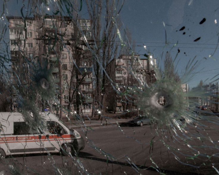 An ambulance is seen through the damaged window of a vehicle hit by bullets, as Russia's invasion of Ukraine continues, in Kyiv, Ukraine February 28, 2022. Jedrzej Nowicki/Agencja Wyborcza.pl via REUTERS