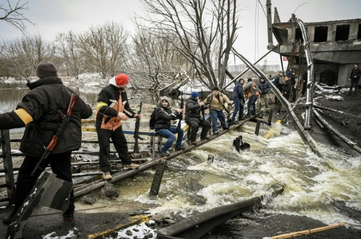 Ukraine forces have been blowing up bridges and setting up barricades across the city to stall Russia's invasion by any means possible