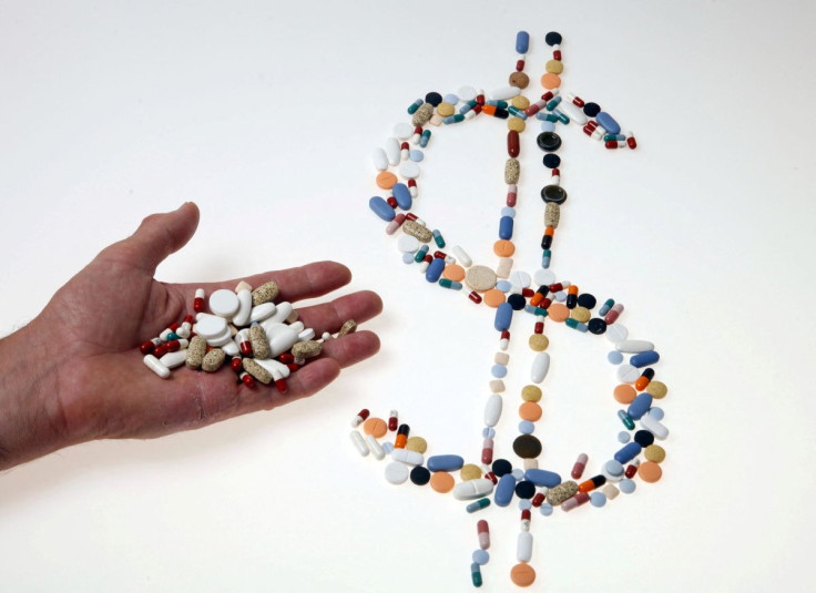 Pharmaceutical tablets and capsules are arranged in the shape of a U.S. dollar sign on a table in this picture illustration taken in Ljubljana August 20, 2014.   