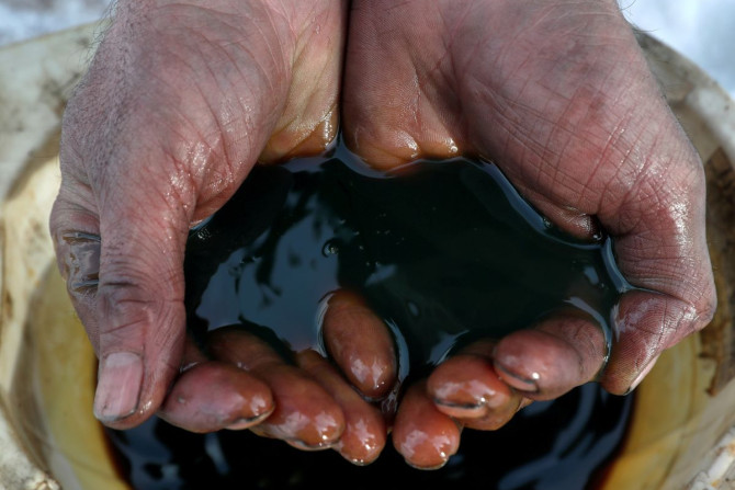 An employee holds a sample of crude oil at the Yarakta oilfield, owned by Irkutsk Oil Co, in the Irkutsk region, Russia on March 11, 2019. 
