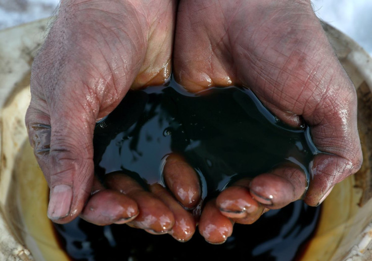 An employee holds a sample of crude oil at the Yarakta oilfield, owned by Irkutsk Oil Co, in the Irkutsk region, Russia on March 11, 2019. 