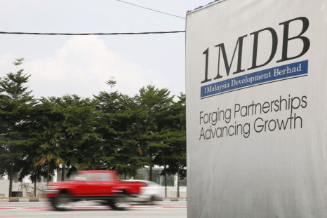Traffic passes a 1Malaysia Development Berhad (1MDB) billboard at the Tun Razak Exchange development in Kuala Lumpur, Malaysia, July 6, 2015. 