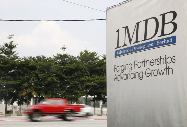 Traffic passes a 1Malaysia Development Berhad (1MDB) billboard at the Tun Razak Exchange development in Kuala Lumpur, Malaysia, July 6, 2015. 