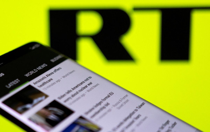 RT app is seen on a smartphone in front of their logo in this illustration taken February 28, 2022. 