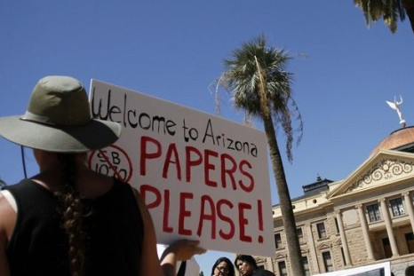 A demonstrator holds a sign during an immigration rally in Arizona