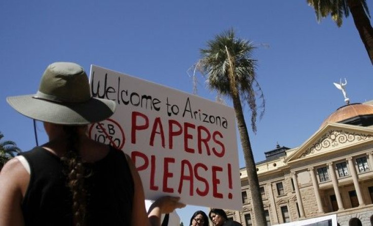 A demonstrator holds a sign during an immigration rally in Arizona