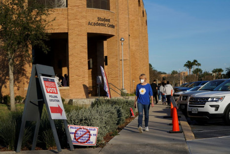 People walk towards a line to vote in the primary election in Edinburg, Texas, U.S. March 1, 2022.  