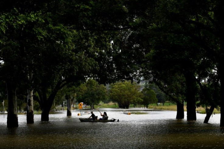 Residents kayak through a flooded street in Grafton, New South Wales, after a storm front dumped vast amounts of water
