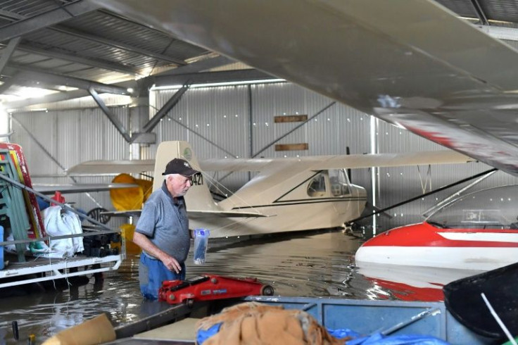 Former pilot Bob King checks planes in the flooded airport hanger at Grafton Air Strip in Grafton, New South Wales