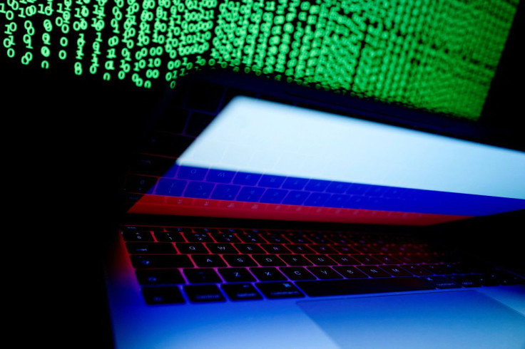 A Russian flag is seen on the laptop screen in front of a computer screen on which cyber code is displayed, in this illustration picture taken March 2, 2018.
