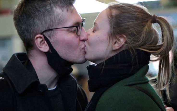 Russian software engineer Mikhail Liublin kisses his Ukrainian girlfriend at a train station, after fleeing Russia's invasion of Ukraine, in Zahony, Hungary March 1, 2022 in this still image taken from a video. REUTERS TV via REUTERS NO RESALES. NO ARCHIV