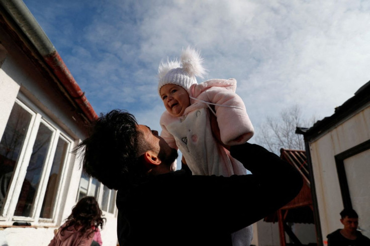 A boy, who fled Russia's invasion of Ukraine, plays with a baby at a local resident's home, in Tiszabecs, Hungary March 2, 2022.