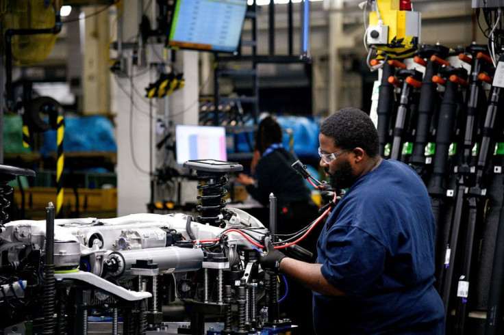 A worker attaches a wiring harness to the chassis of an X model SUV at the BMW manufacturing facility in Greer, South Carolina, U.S. November 4, 2019.