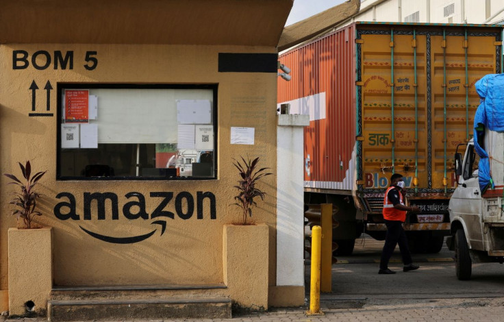 A man inspects trucks before they enter an Amazon storage facility on the outskirts of Mumbai, India, October 1, 2021.