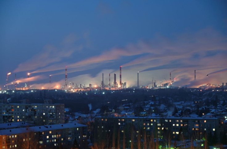 A general view shows a local oil refinery behind residential buildings in Omsk, Russia February 10, 2021. 