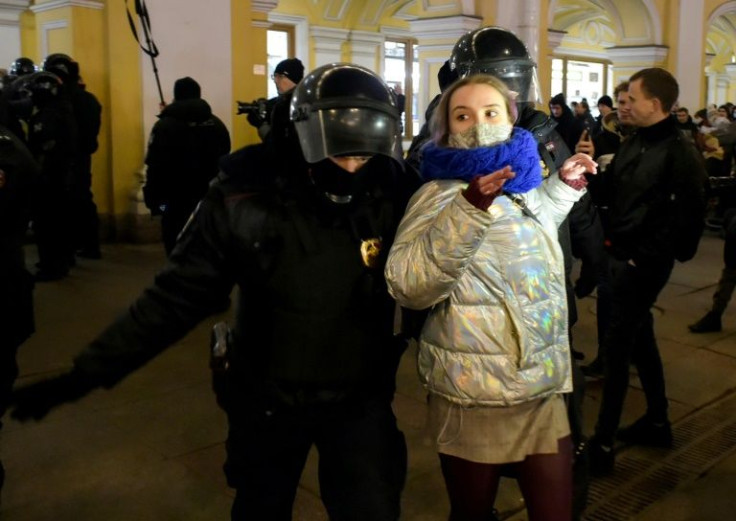 Police officers detain a woman during a protest against Russia's invasion of Ukraine in Saint Petersburg