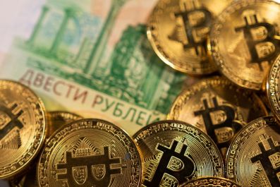 Russian rouble banknotes and representations of the cryptocurrency Bitcoin are seen in this illustration taken March 1, 2022. 
