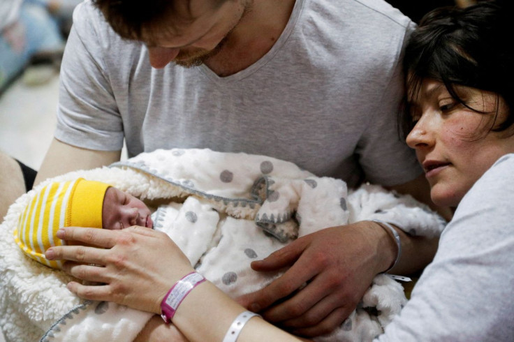 A couple with their newborn baby take shelter in the basement of a perinatal centre as air raid siren sounds are heard amid Russia's invasion of Ukraine, in Kyiv, Ukraine, March 2, 2022.