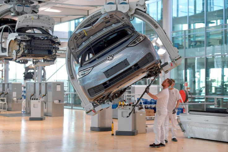 Technicians work in the assembly line of German carmaker Volkswagen's electric ID. 3 car in Dresden, Germany, June 8, 2021.