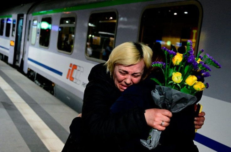 A woman is comforted by a friend after arriving on a train from Ukraineâs border at Berlinâs main train station on March 2, 2022