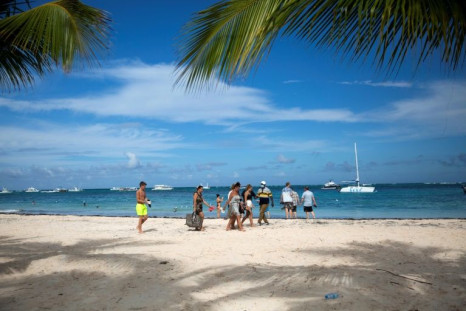 Tourists enjoy a beach in Punta Cana in the Dominican Republic, on January 7, 2022