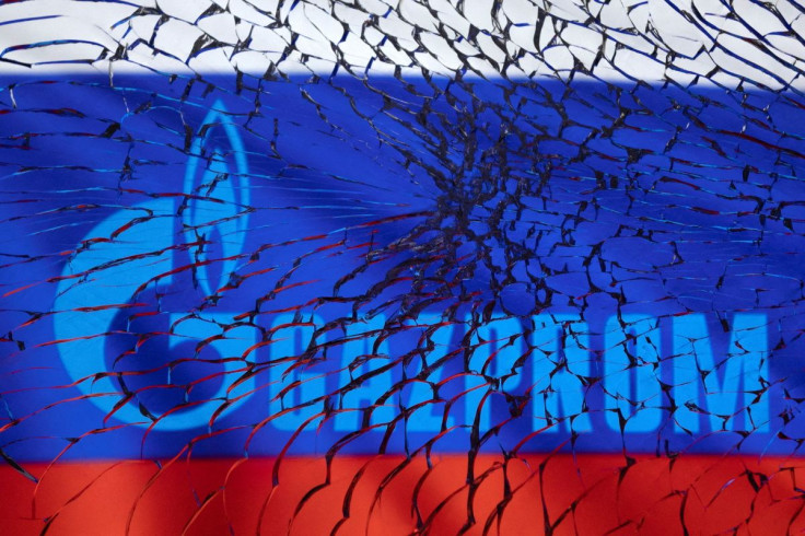 Gazprom logo and Russian flag are seen through broken glass in this illustration taken March 1, 2022. 