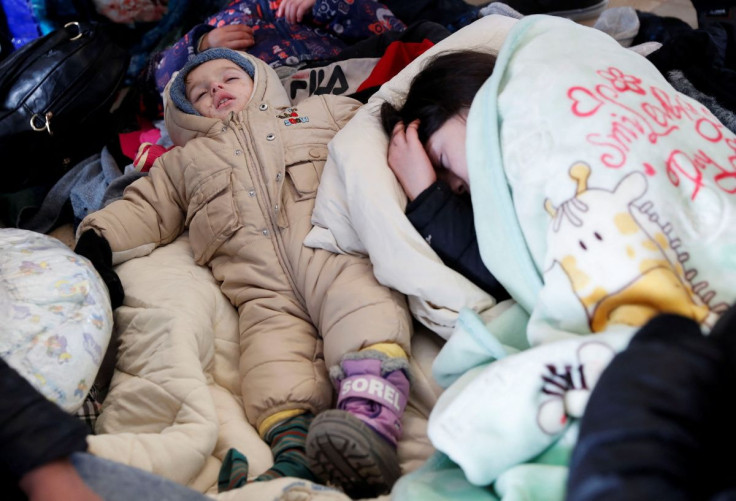 Children sleep on the floor of the train station, after fleeing Russia's invasion of Ukraine, in Zahony, Hungary March 3, 2022.
