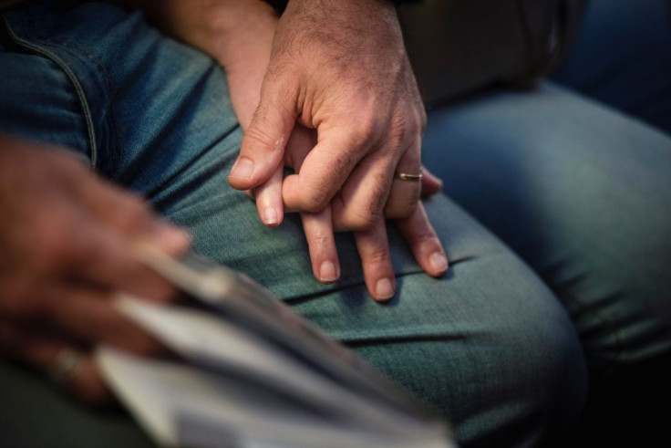 Lyudmyla Bots and Viktor Paniouk, who met and fell in love in Kiev in October 1990 during a hunger strike for Ukrainian independence from the Soviet rule, hold hands as they attend a mass at the Ukrainian Catholic Eparchy of Santa Maria del Patrocinio aft