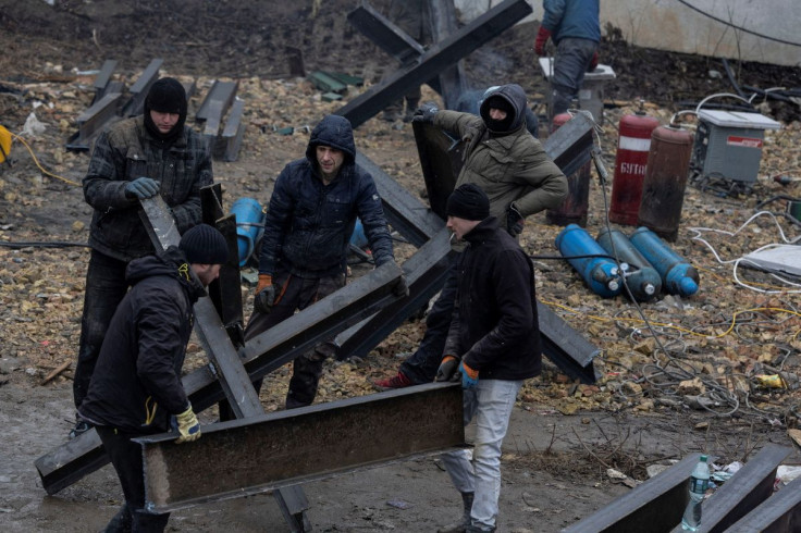 Workers from a local construction company weld anti-tanks obstacles to be place on road around Kyiv, Ukraine March 3, 2022. 