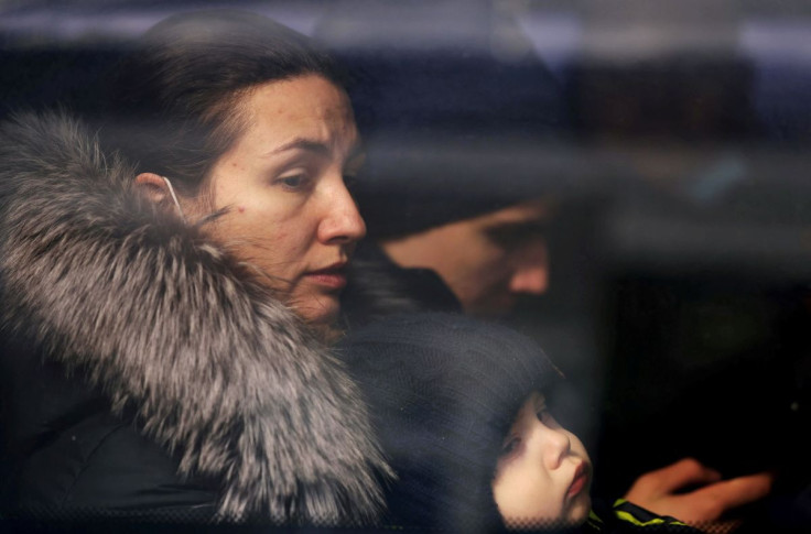 A woman and a child fleeing Russia's invasion of Ukraine sit inside a bus at a border crossing in Vysne Nemecke, Slovakia March 3, 2022.
