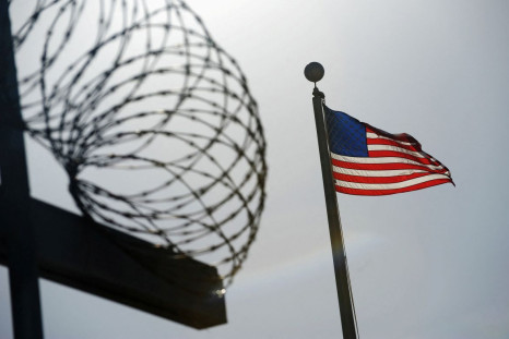 A U.S. flag flies above a razorwire-topped fence at the "Camp Six" detention facility at U.S. Naval Station Guantanamo Bay December 10, 2008. 