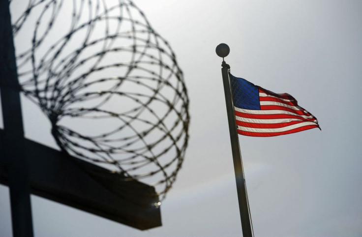 A U.S. flag flies above a razorwire-topped fence at the "Camp Six" detention facility at U.S. Naval Station Guantanamo Bay December 10, 2008. 