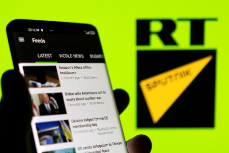 RT app is seen on a smartphone in front of RT and Sputnik logo in this illustration taken February 28, 2022. 