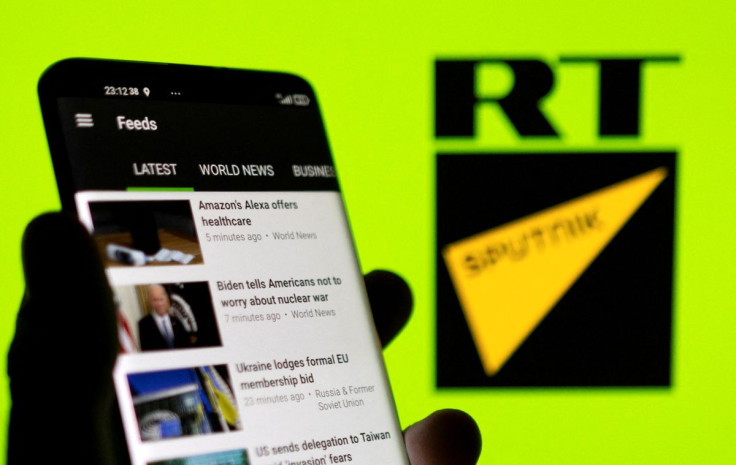 RT app is seen on a smartphone in front of RT and Sputnik logo in this illustration taken February 28, 2022. 