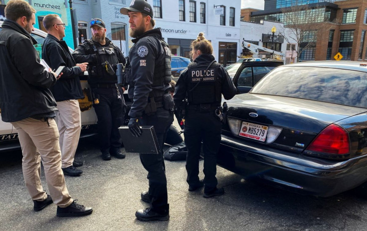 U.S. Secret Service officers search a car with Indiana license plates and detain two men inside who had what appeared to be an assault-style rifle and body armor when officers searched and emptied the car on Wisconsin Avenue in the Georgetown neighborhood