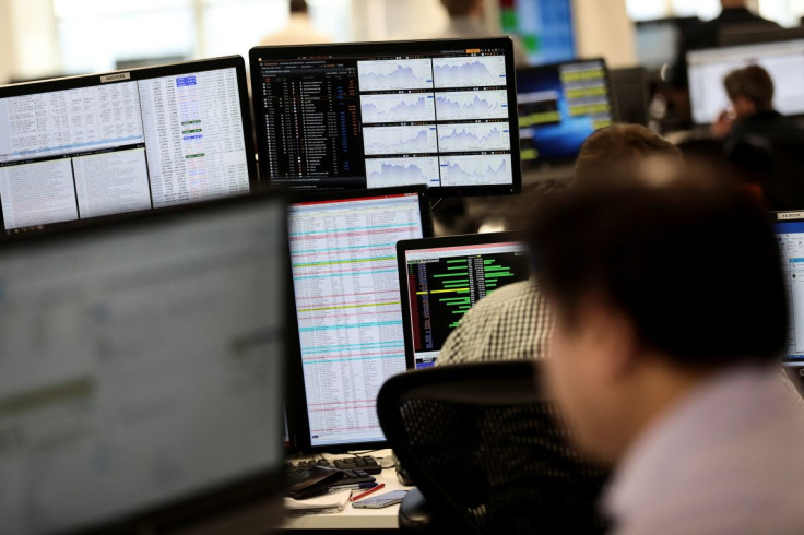 Traders looks at financial information on computer screens on the IG Index trading floor in London, Britain February 6, 2018. 