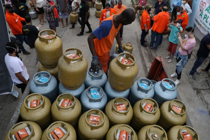 A worker unloads cooking gas cylinders for residents to buy at a fair price amid high energy prices caused by inflation, as part of an initiative organised by the Federation of Oil Workers (FUP), in Vila Vintem slum, Rio de Janeiro, Brazil October 28, 202