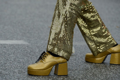 A man wearing 1970s-themed golden shoes and clothes dances on the street during the Schlagermove festival in Hamburg July 7, 2012. 